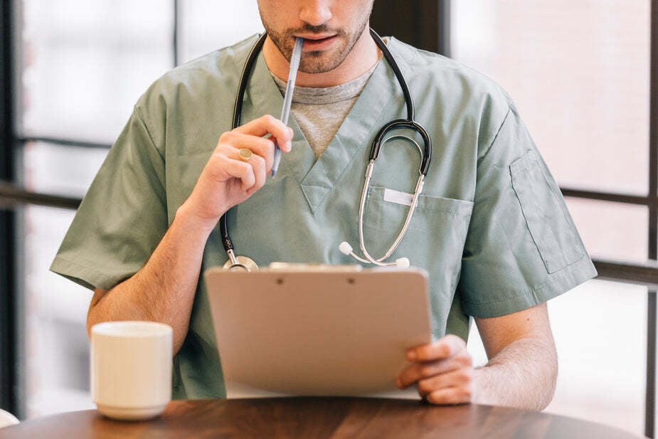 doctor-looking-at-clipboard