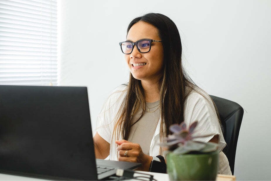 woman-works-at-her-desk-with-a-laptop